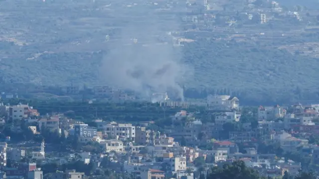 Smoke rises above buildings on the Lebanese side of the Israel-Lebanon border