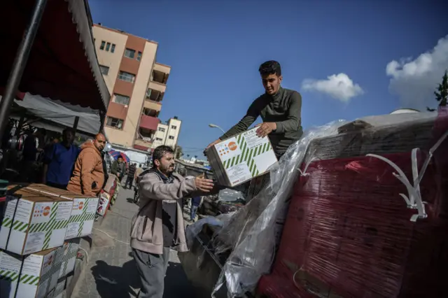 Men unload boxes from a truck