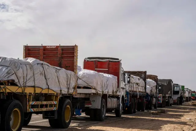 Trucks carrying aid await an opportunity to enter Gaza via the Rafah crossing