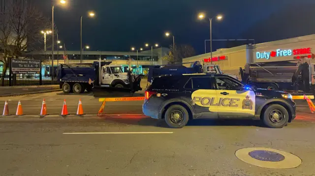 Police cars block traffic near the Rainbow Bridge