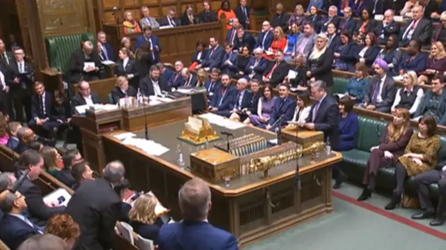 Keir Starmer at the despatch box in the House of Commons, with assembled MPs watching