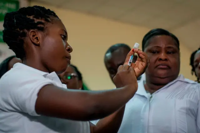 A nurse of Ewin Polyclinic takes Malaria vaccine  from a bottle to administer it to a child, at Pempamsie Hotel, Cape Coast, Ghana, on April 30, 2019