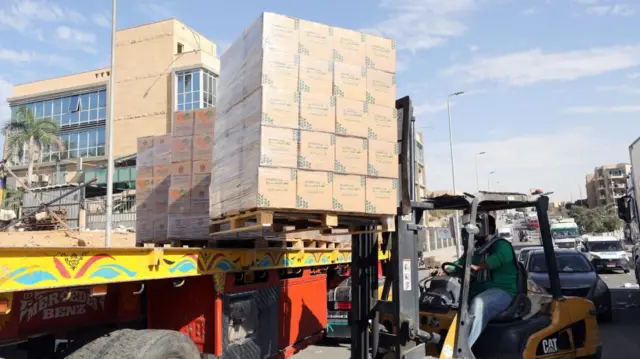 Food boxes are loaded onto lorries bound for Gaza