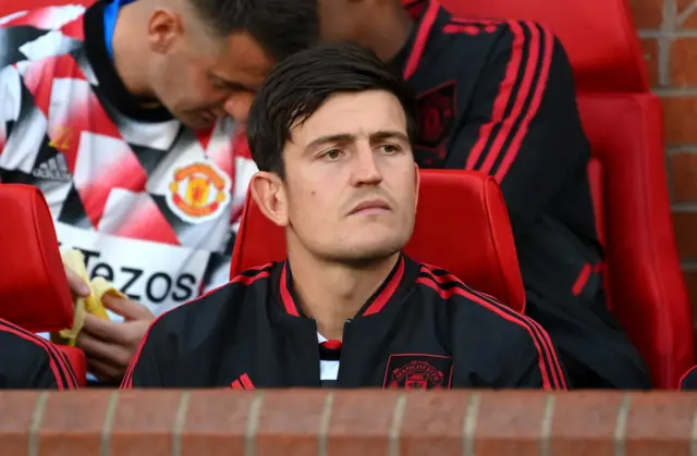 Harry Maguire of Manchester United looks on from the substitutes bench prior to the Premier League match between Manchester United and Liverpool FC at Old Trafford on August 22, 2022 in Manchester, England