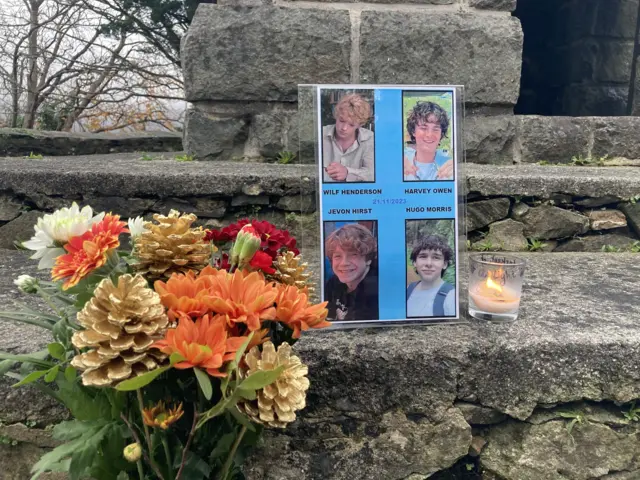 Photo, flowers and candle left on a step