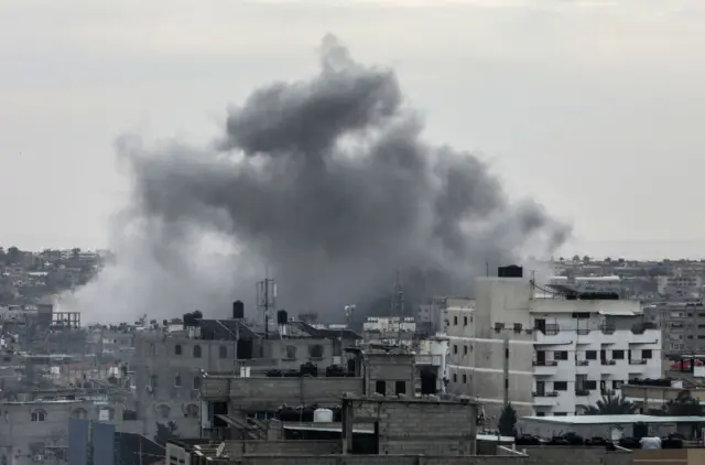 Smoke rising above buildings