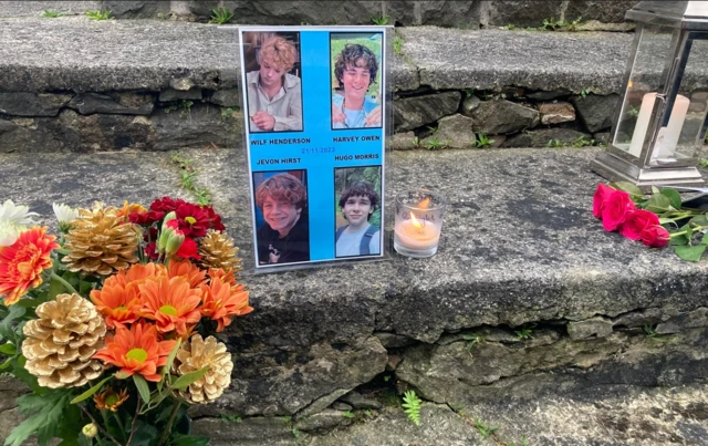 Photo, candle and flowers on a step