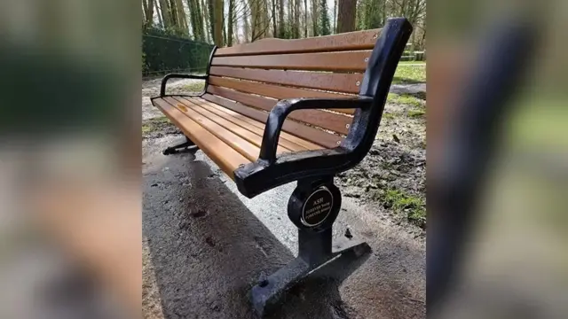 A memorial bench for Ashley Dale in park