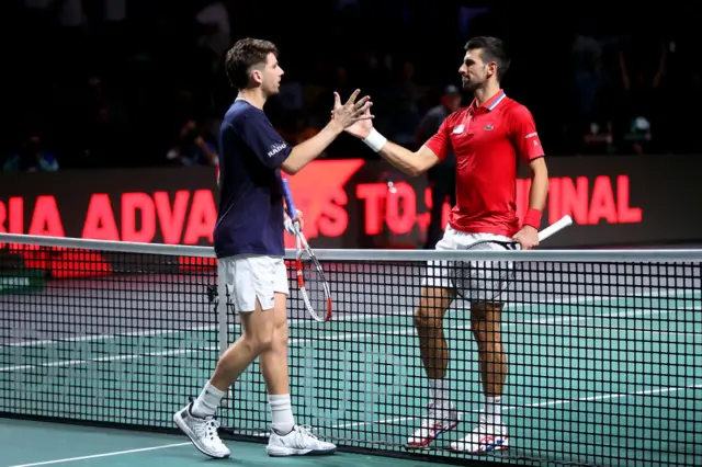 Cameron Norrie and Novak Djokovic shake hands at the set