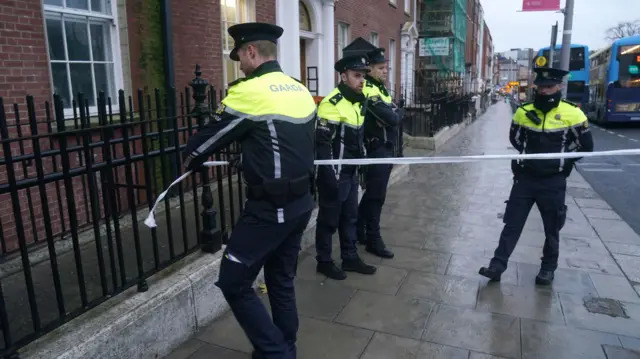 Police officers roll tape out at the scene of a stabbing in Dublin