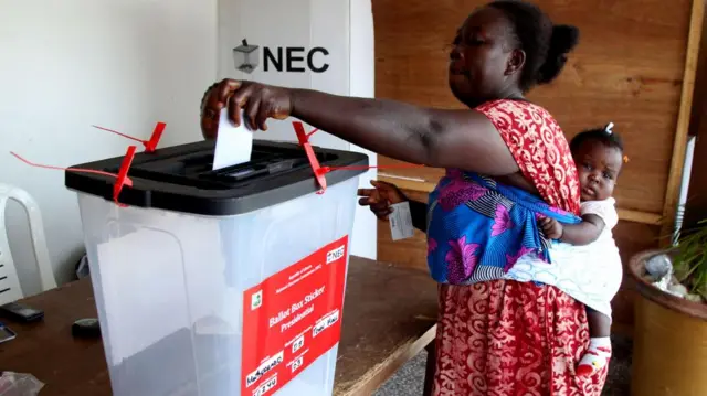 A woman casts her ballot during the presidential election, at a polling station at Paynesville town hall in Paynesville, outside Monrovia, Liberia, 14 November 2023