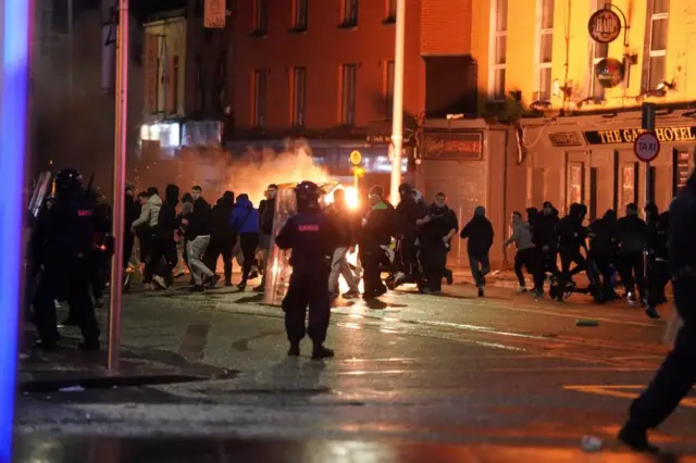 Riot police and a crowd in Dublin city centre