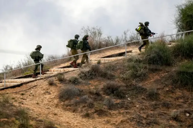 Israeli soldiers patrol near the Gaza border