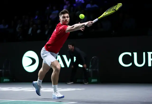 Miomir Kecmanovic stretches to reach the ball on his backhand