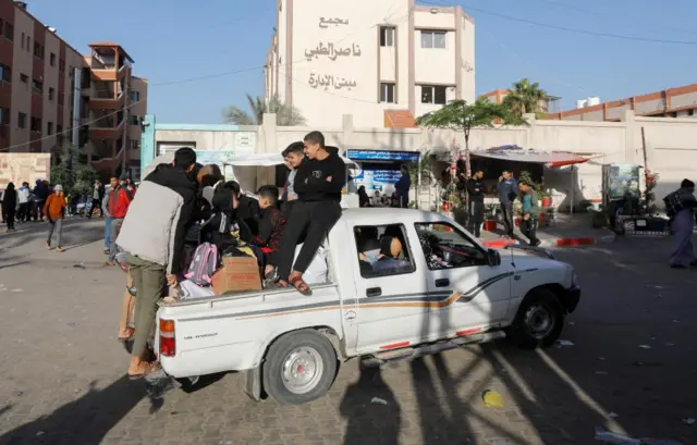 Men sitting on the back of a pickup truck