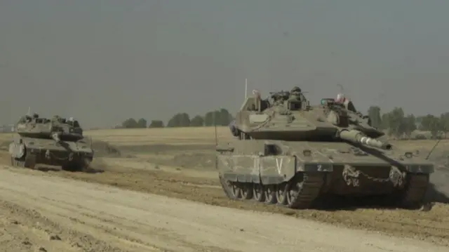 Two IDF tanks on a road out of north Gaza