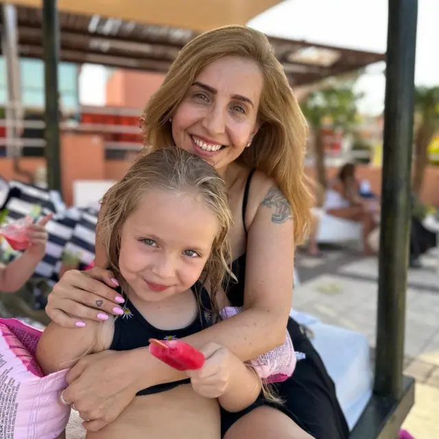 Daniele Aloni holds her daughter Emilia in a picture taken before they were kidnapped