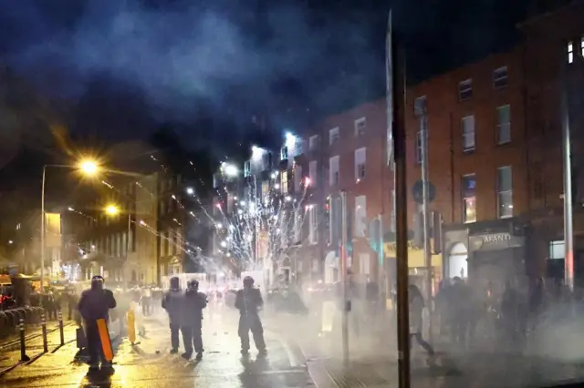 Fireworks are thrown at police officers as a riot breaks out in Dublin, Ireland on 23 November