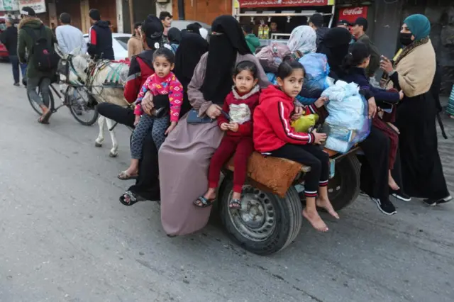 Children ride on a donkey cart through Gaza