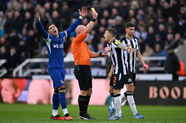 Keiran Trippier complains to the referee about his yellow card.