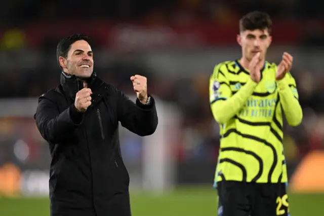 Mikel Arteta pumps his fists in celebration.