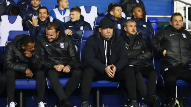 Wayne Rooney sits on the Birmingham bench