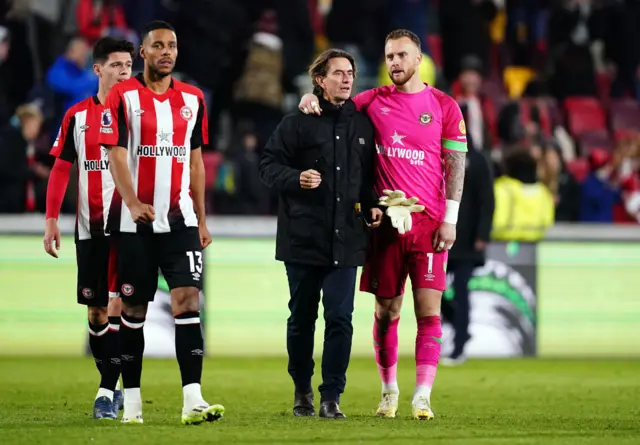 Thomas Frank and Mark Flekken leave the pitch at the end of the game.