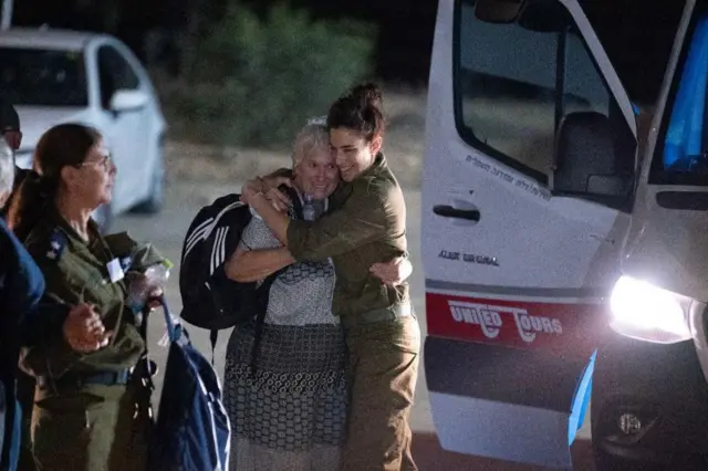 Margalit Mozes hugging an Israeli soldier upon her release