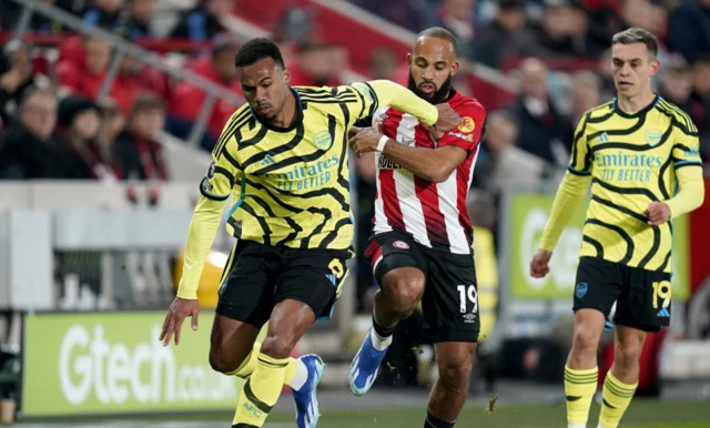 Gabriel and Brentford's Bryan Mbeumo battle for the ball