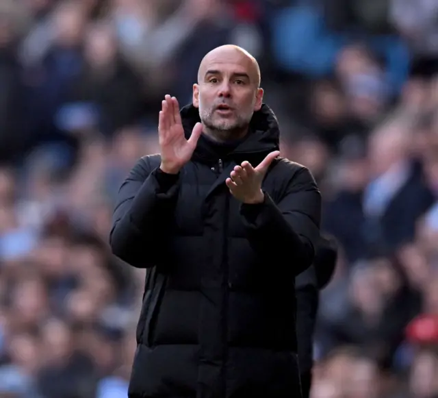 Pep Guardiola clapping.