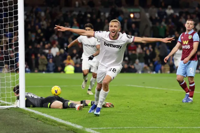 Tomas Soucek opens his arms in celebration.