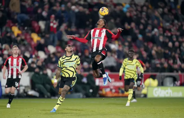 Ethan Pinnock in action heading the ball.