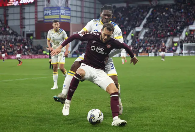 Hearts' Jorge Grant and St Johnstone's Daniel Phillips in action during a cinch Premiership match between Heart of Midlothian and St Johnstone at Tynecastle Park