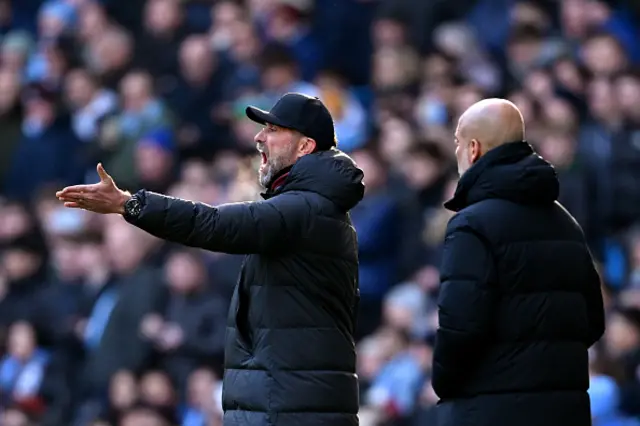 Jurgen Klopp, Manager of Liverpool, reacts alongside Pep Guardiola