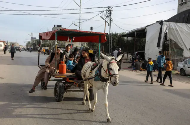 Palestinians get in line to get gas for cooking as