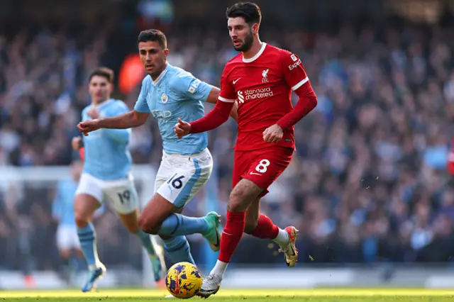 Dominik Szoboszlai on the ball as Rodri puts pressure on him