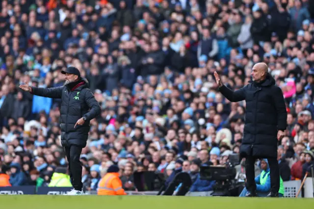 Jurgen Klopp and Pep Guardiola on the sideline.