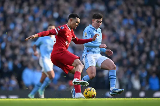 Trent Alexander-Arnold of Liverpool and Julian Alvarez of Manchester City battle for possession