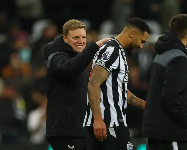 Eddie Howe congratulates a Newcastle player.