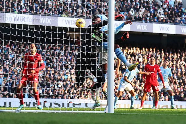 Manuel Akanji of Manchester City collides with Alisson Becker