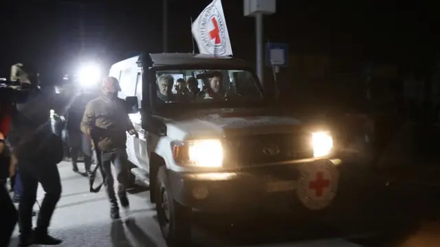 A Red Cross vehicle, as part of a convoy believed to be carrying hostages abducted by Hamas militants during the October 7 attack on Israel, arrives at the Rafah border, amid a hostages-prisoners swap deal between Hamas and Israel, in southern Gaza Strip November 25, 2023.