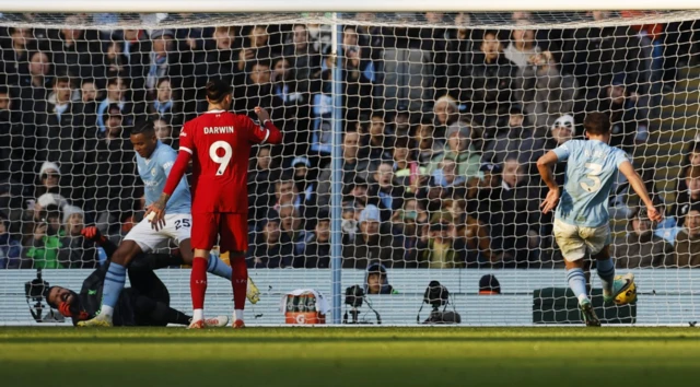 Ruben Dias taps the ball into the net as Alisson is fouled by Akanji