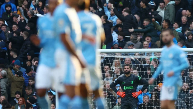 Alisson looks on after conceding a goal