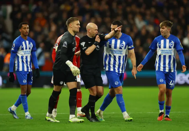 Referee Anthony Taylor points to Lewis Dunk leaving the field.