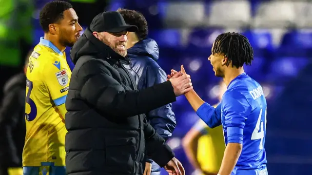 Wayne Rooney shakes hands with Birmingham player