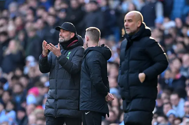 Jurgen Klopp, Manager of Liverpool, reacts and Pep Guardiola looks on