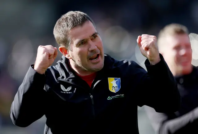 Mansfield Town manager Nigel Clough celebrating a win