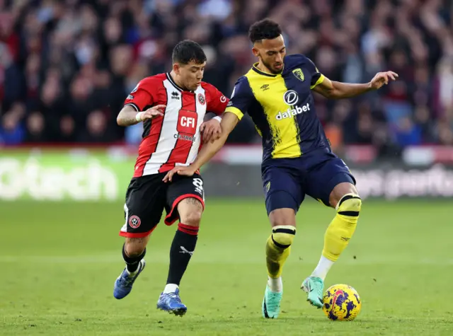 Lloyd Kelly with the ball, challenged by Gustav Hamer.