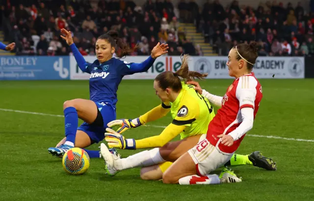 Arsenal's Caitlin Foord in action with West Ham United's Amber Tysiak and Megan Walsh.