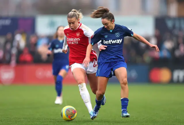 Alessia Russo and Lisa Evans in a tackle.